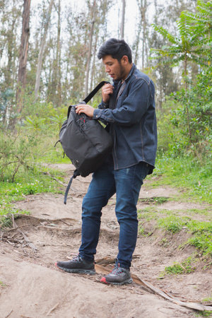 Young man walking in the woods taking selfies. To show your friends.の写真素材