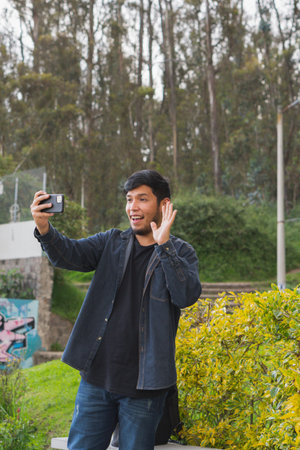 Young man walking in the woods taking selfies. To show your friends.の写真素材