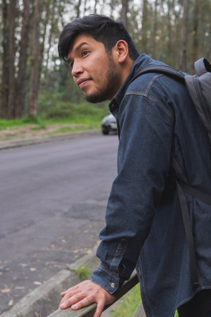 Young man walking in the woods taking selfies. To show your friends.の写真素材