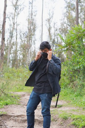 Young man walking in the woods taking selfies. To show your friends.の写真素材