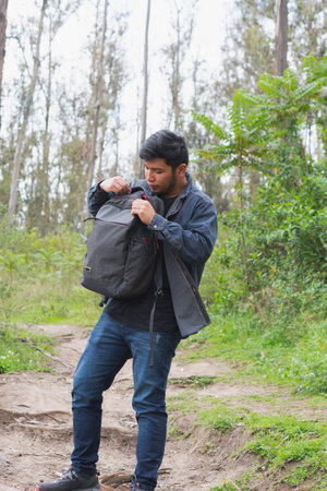 Young man walking in the woods taking selfies. To show your friends.の写真素材