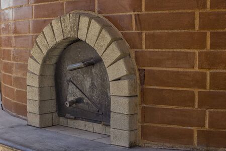 Metal door of brick oven used for making bread and pizzaの写真素材