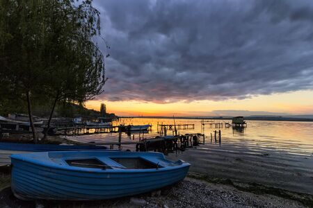 fishing boat on the beach at the sunsetの写真素材