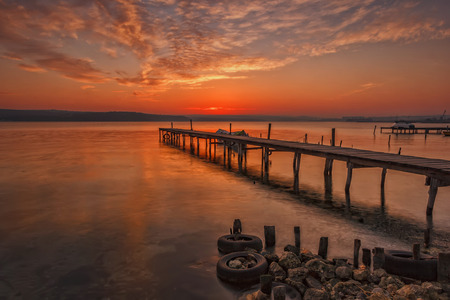 Stunning sunset at the harbour with wooden pierの写真素材