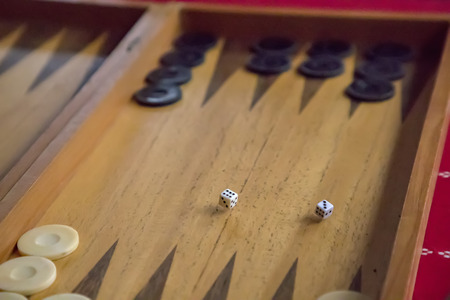 thrown dice on the table while playing backgammon