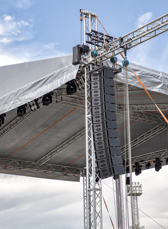 stage lighting and sound equipment on the outdoor stage before a concertの写真素材