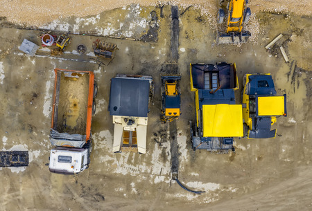 Amazing aerial view of asphalt spreading machines and truck at a construction site. Road...