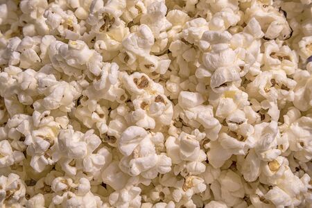 Scattered salted popcorn, food texture background. Fastfood popular during a movie in a cinema. Popcorn texture. Popcorns.の写真素材
