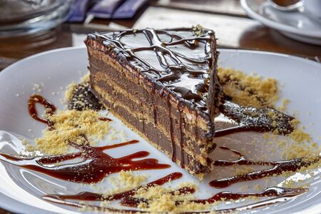 a gourmet piece of chocolate cake, torte on a decorated plate. Selective focus