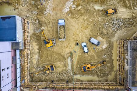 Heavy construction equipment working at the construction site. Aerial view from droneの写真素材