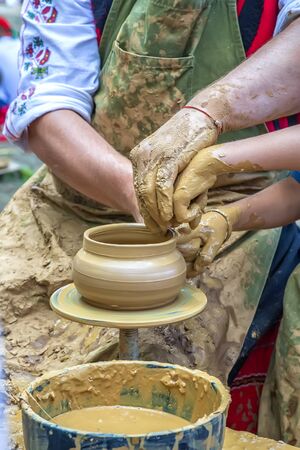 A master of pottery craftsmanship teaches a child who wants to learn how to sculpt a jug. Pottery...