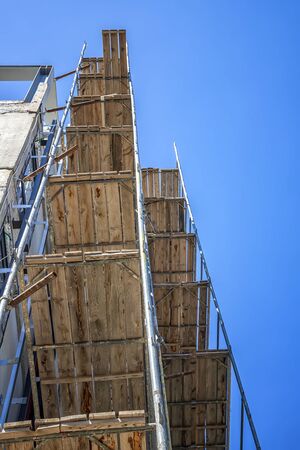 Construction site with scaffold building, scaffolding on a new building.
