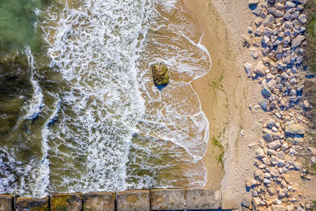 Aerial top view from drone to the seacoast with beauty waves and stony beach. Sea background.の写真素材