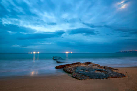 exciting calm sea with impressive stormy clouds early morningの写真素材