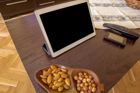 Comfortable home office. Tablet, nuts, phone, Tvの写真素材
