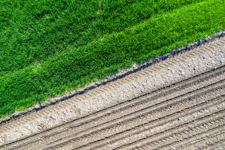 Aerial top view. Rows of soil before and after planting.の写真素材
