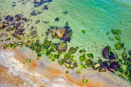 Aerial top view from drone of coastline surface with crystal clear sea water  with rocks and...