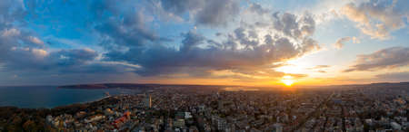 Panoramic view of the amazing sunset sky over the cityの写真素材