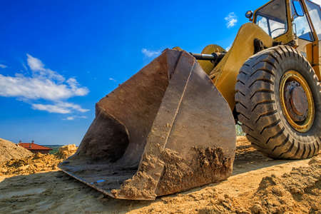Close up of a big bucket of a yellow excavatorの写真素材