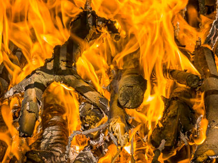 Beautiful orange fire, the flame of fire on wood, fireplace fiery close-up.  Hot Burning flames of...