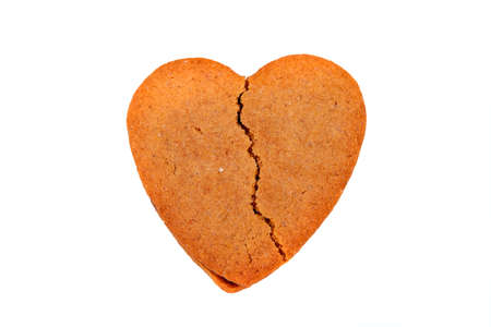 Biscuit like a broken heart shape, isolated on white backgroundの写真素材