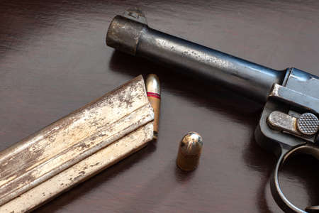 close-up of gunpoint and bullets on table. Weapons and ammunition.の写真素材