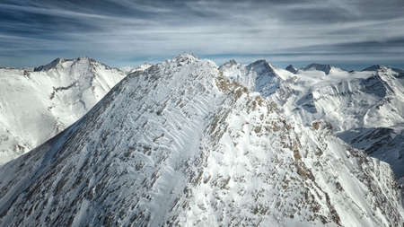 Amazing view from a drone over the snowy mountain hillsの写真素材