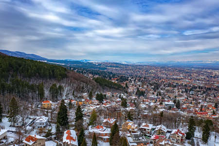 Beautiful view of the city covered with snow at the base of the mountain. Sofia, Bulgariaの写真素材