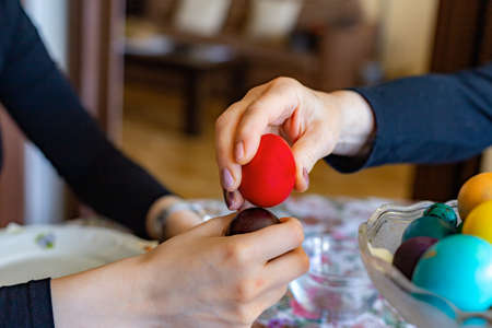 Hands Knocking Easter Eggs.  Fight game seasonal tradition.の写真素材