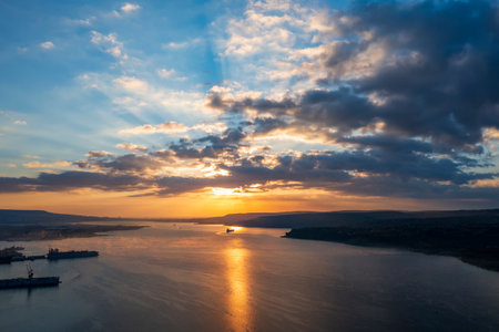 Amazing sun way and rays between clouds at sunset over the sea.の写真素材