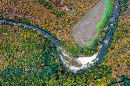 Aerial view from drone of the river across mountain hills with autumn treesの写真素材