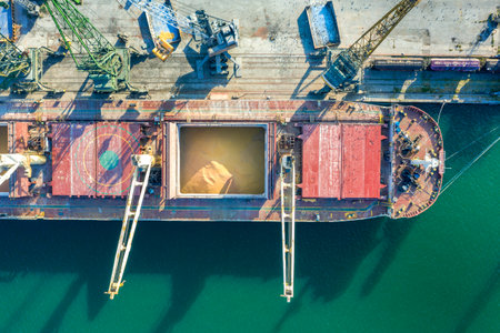 Top view from a drone of a large ship loading grain for export. Water transportの写真素材