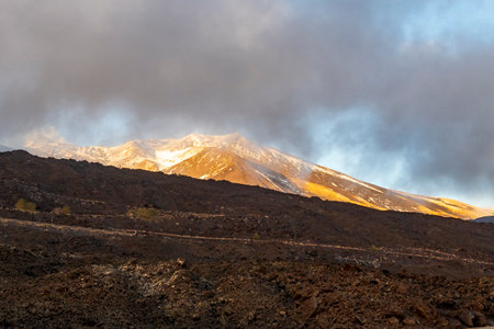 View of the volcanic rocks and volcano Etna in Sicily from a roadの写真素材