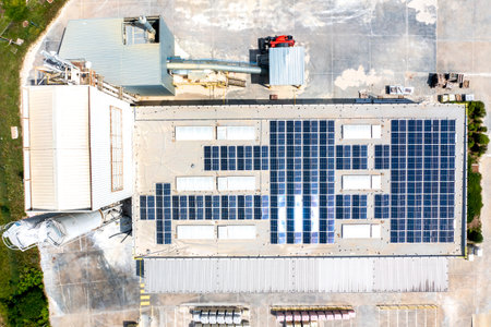 solar panels on the roof of a industrial building. Aerial view from drone