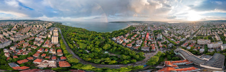 Stunning panorama of the city and rainbow over the seaの写真素材