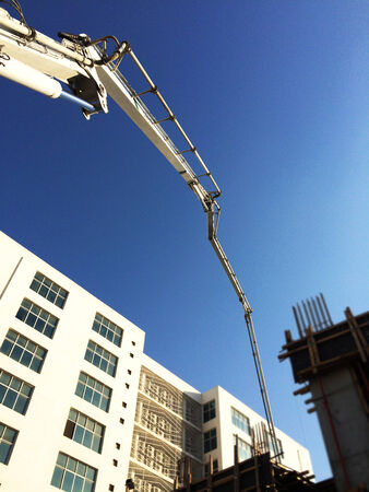 Machine at construction site pouring concreteの写真素材