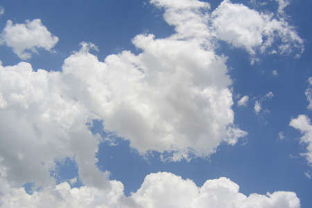 in a large white interesting form the cloud is seen about the approach of rain in the sky above the blue colorの写真素材
