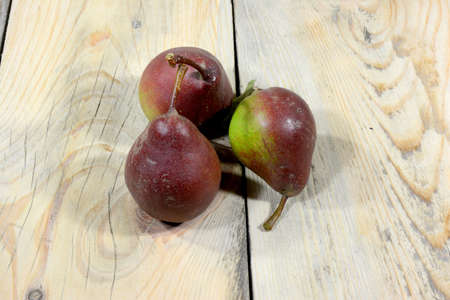 Three very beautiful and delicious pears are placed on a table made of worn-out shoesの写真素材