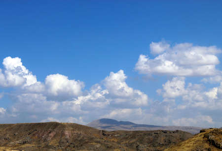 In the evening white clouds hover on the top of Vayots mountainの写真素材