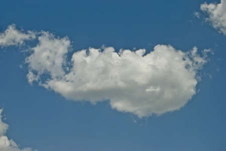 the blue sky is floating here is a beautiful white cloudの写真素材