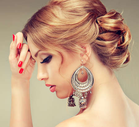 Beautiful model with red manicure and elegant hairstyleの写真素材