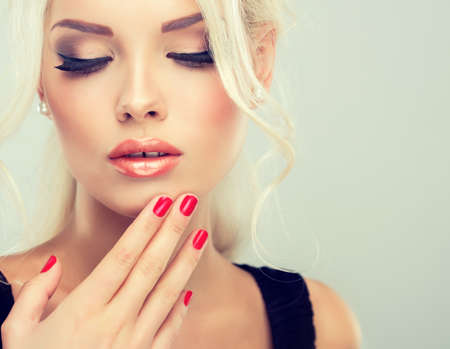 Beautiful model with retro hair style bouffant hair and a bushy tail. Red nails manicureの写真素材