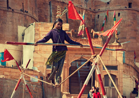 Indian girl tightrope walker at work. Children labor.のeditorial素材