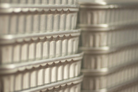 Color photo of grey metal aluminium cans of tinned sardine fish tins stacked up with shallow depth of focus.の写真素材