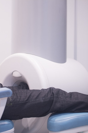 Patient and Doctor in fully open high field Magnetic Resonance Image MRI CAT Scan scanning knee and leg.の写真素材