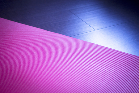Red fitness, yoga and pilates foam mats in sports aerobics gymnasium. Artistic photo.の写真素材