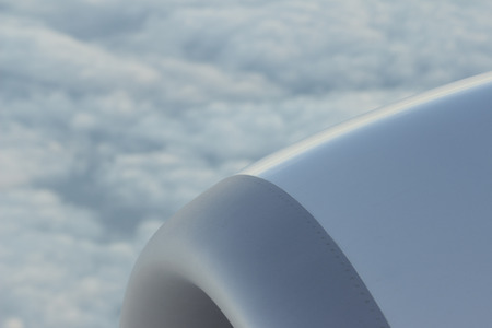Airplane flying in sky in flight engine wing.