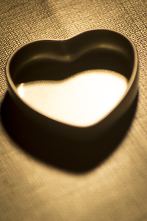 Love heart shape metal tin on table photo.の写真素材