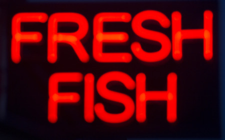 Fresh fish  neon sign at night in street photo.の写真素材