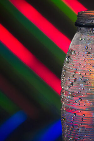 Empty plastic soda bottle in silhouette on color background photo.の写真素材